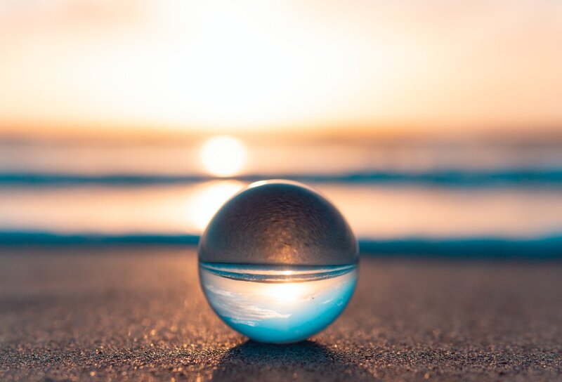 Image of a crystal ball on a relaxing ocean shore