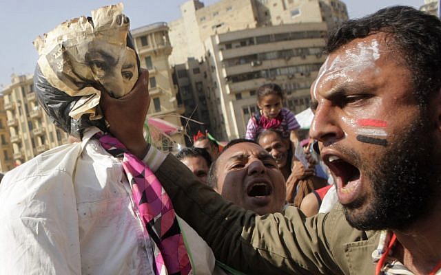 An Egyptian protester prepares to hang an effigy representing Hosni Mubarak at Tahrir Square last Friday (photo credit: AP/Amr Nabil)
