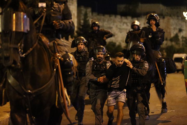 JERUSALEM - APRIL 23: Israeli forces intervene Palestinian Muslims, who gathered in Damascus Gate after performing Tarawih pr