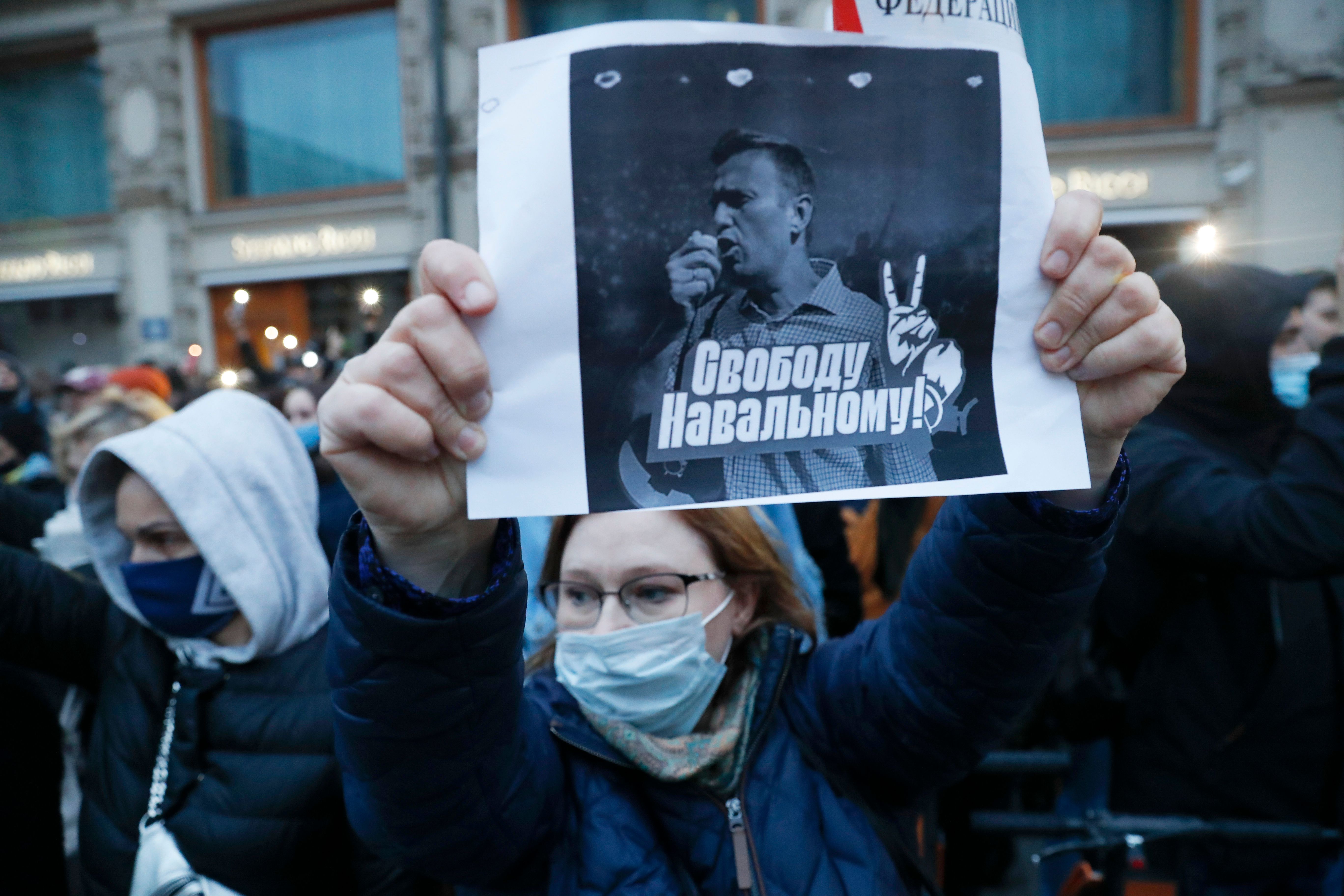 A activist holds a poster reading "Freedom for Navalny!" during the opposition rally in support of jailed opposition leader A