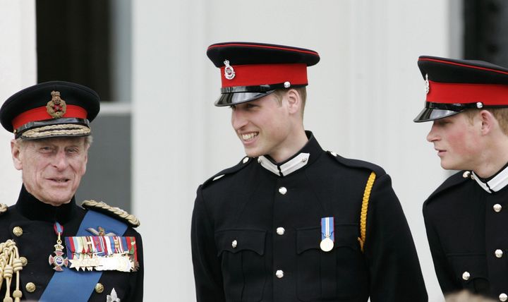 Prince Philip talks with his grandsons Prince William and Prince Harry at the Sovereign's Parade at Sandhurst Military Academ