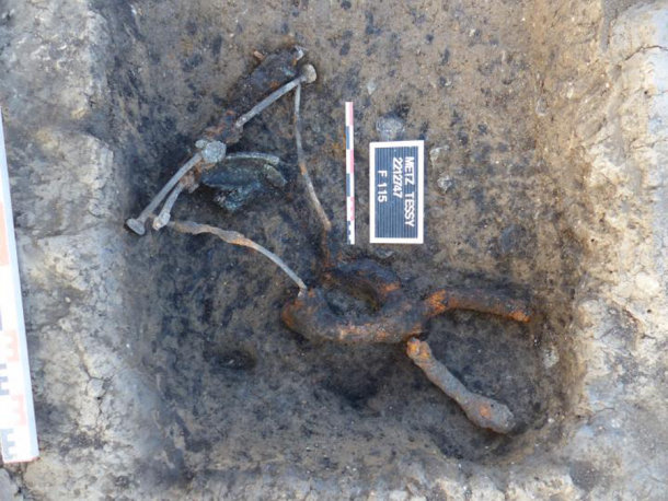 The metal remains of the recently found Roman curule chair as it was discovered. (©Emmanuel Ferber, INRAP)
