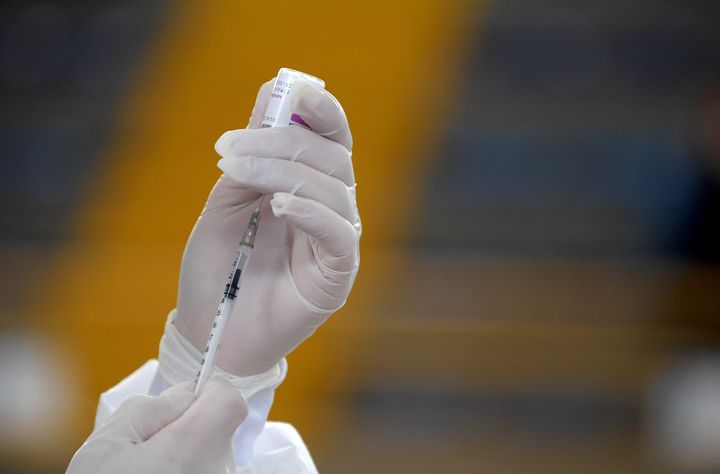A health worker prepares a shot of the Oxford/AstraZeneca vaccine against COVID-19