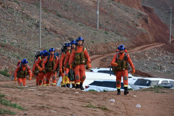 Rescuers walk into the accident site to search for survivors in Jingtai County of Baiyin City, northwest China's Gansu Provin
