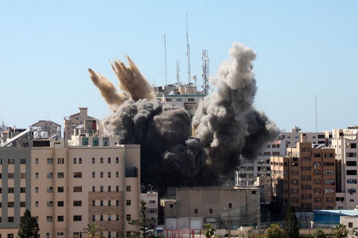 A thick column of smoke rises from the Jala Tower as it is destroyed in an Israeli airstrike in Gaza City on Saturday.&nbsp;