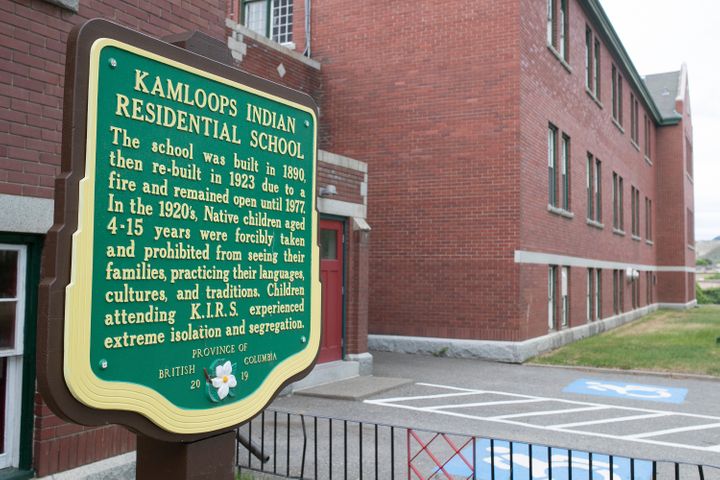 A plaque is seen outside of the former Kamloops Indian Residential School on Tk'emlups te Secw&eacute;pemc First Nation in Ka