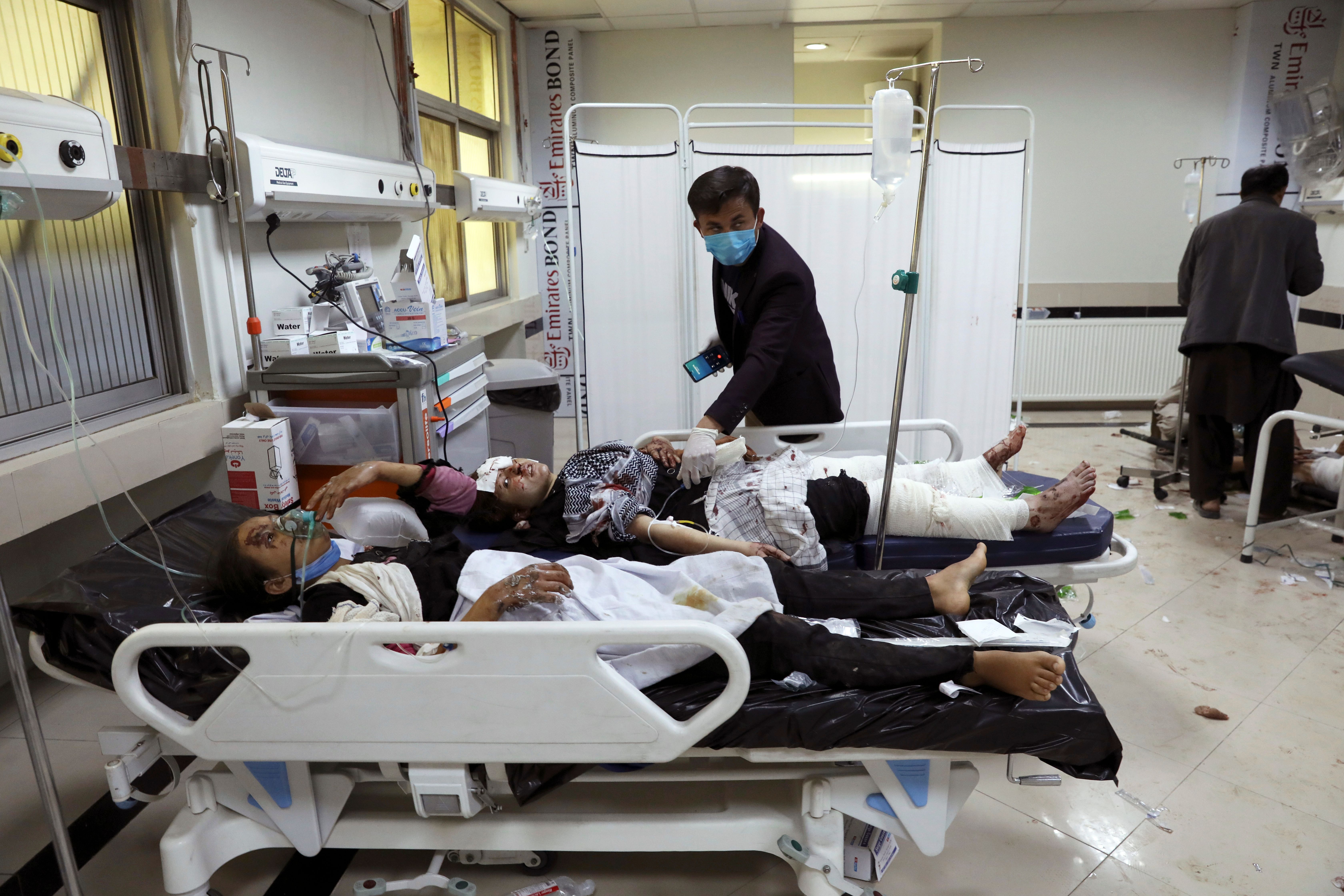 Afghan school students are treated at a hospital after a bomb explosion near a school in west of Kabul, Afghanistan, Saturday