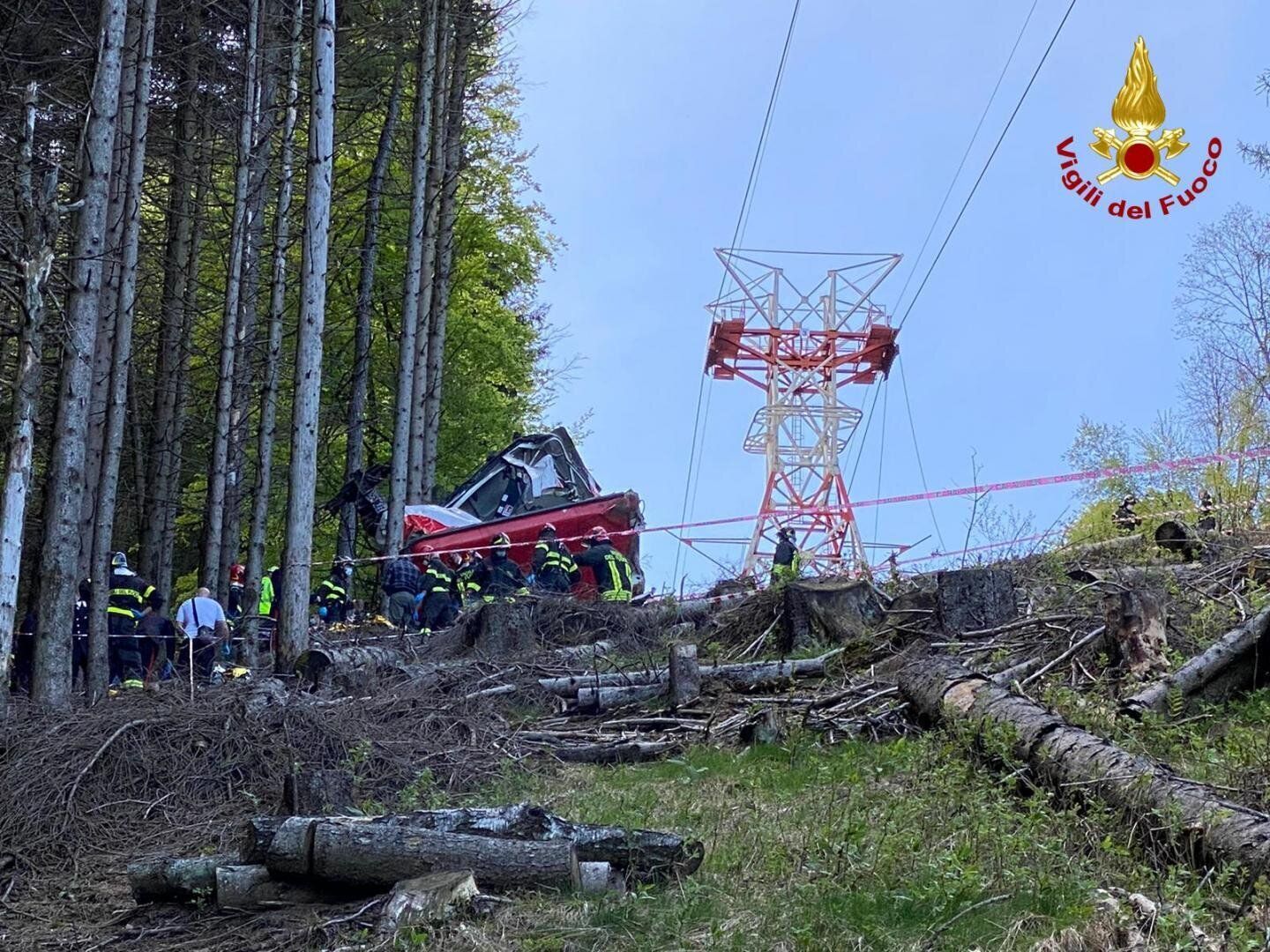 Italian fire fighters are seen near the crashed cable car after it fell from the Stresa-Alpine-Mottarone line near Lake Maggi