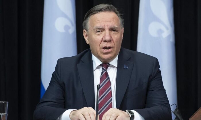 Quebec Premier Francois Legault, centre, speaks during a news conference on the COVID-19 pandemic, on May 11, 2021, at the legislature in Quebec City. (Jacques Boissinot/The Canadian Press)