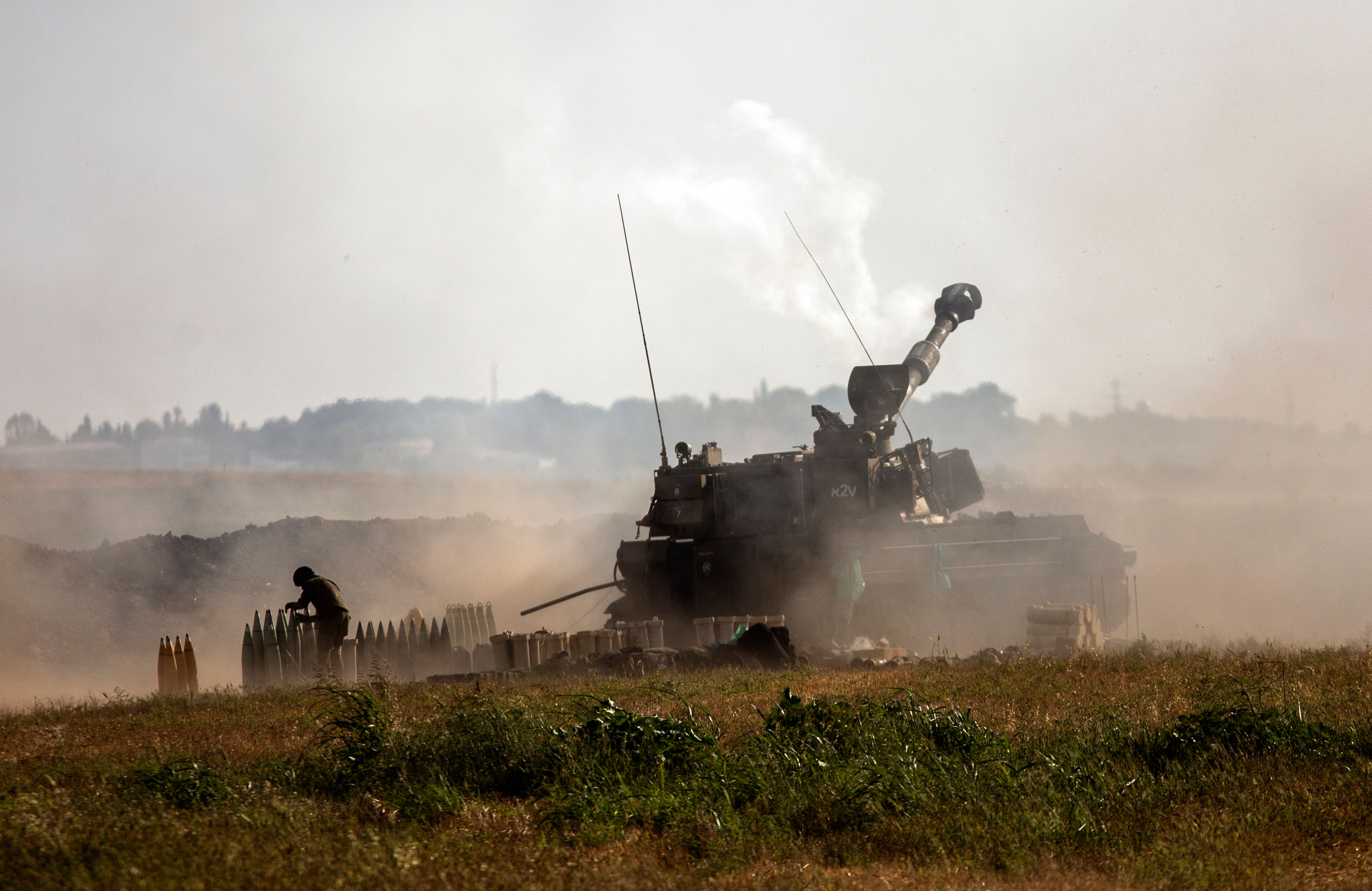 An Israeli artillery unit fires toward targets in the Gaza Strip, at the Israeli-Gaza border, Sunday, May 16, 2021. (AP Photo