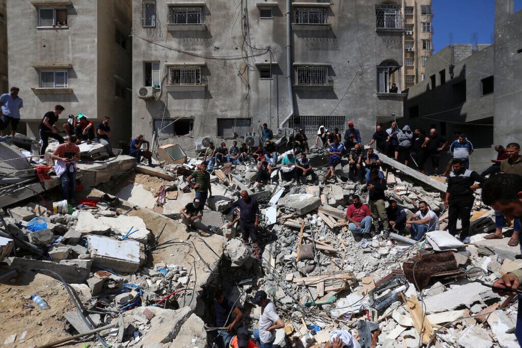 Palestinians search for victims under the rubble of a destroyed building in Gaza City's Rimal residential district following massive Israeli bombardment on May 16, 2021. (Photo: Ashraf Amra/APA Images)