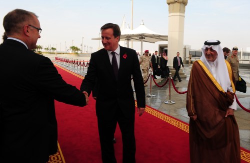 An unidentified official greets British Prime Minister David Cameron (C) as he walks with Saudi Emir of Mecca, Prince Khalid bin Faisal bin Abdulaziz (R), upon his arrival in Jeddah on November 6, 2012 [AMER HILABI/AFP via Getty Images]