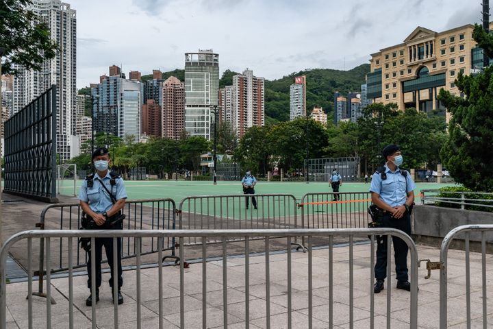 Police stand on patrol at Victoria Park, after closing a venue where Hong Kong people traditionally gather annually to mourn 