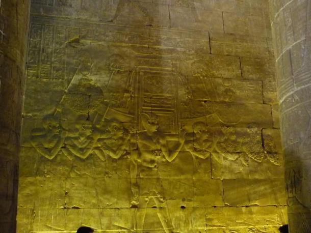 Purified priests carry the sacred barque of Hathor in a wall relief from the Hypostyle Hall at the Edfu temple. Pharaoh walks beside them. (I, Rémih / CC BY-SA 3.0)