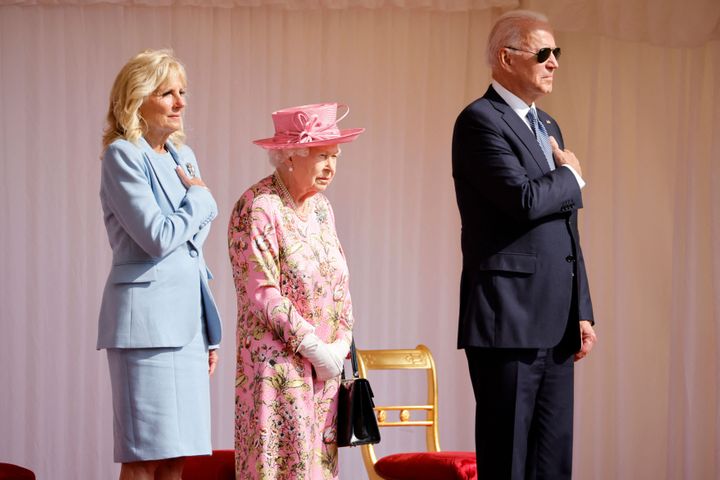 President Joe Biden and First Lady Jill Biden stand beside Britain's Queen Elizabeth II as a Guard of Honour give a Royal Sal