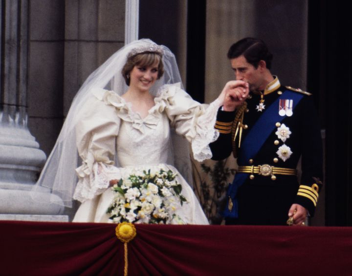 The Prince and Princess of Wales on the balcony of Buckingham Palace on their wedding day, July 19, 1981. Diana wears a weddi