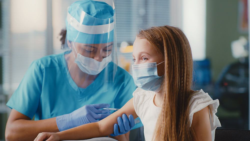 After outrage, Tennessee stops outreach campaign enticing minors to get COVID-19 jabs Nurse-protective-gear-child-inject-vaccine