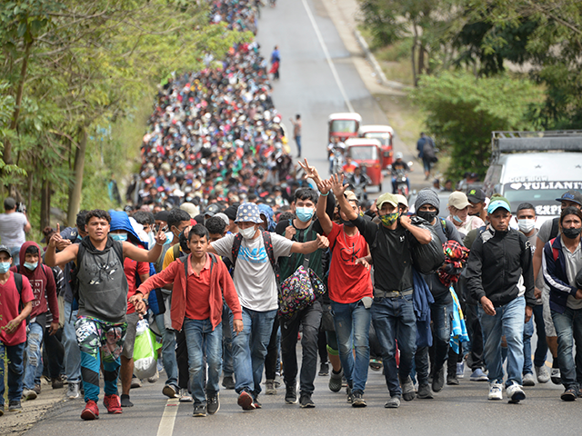 Honduran migrants, part of a caravan heading to the United States, walk along a road in Camotan, Guatemala on January 16, 2021. - At least 4,500 Honduran migrants pushed past police and crossed into Guatemala Friday night, passing the first hurdle of a journey north they hope will take them to a better life in the United States. (Photo by Johan ORDONEZ / AFP) (Photo by JOHAN ORDONEZ/AFP via Getty Images)