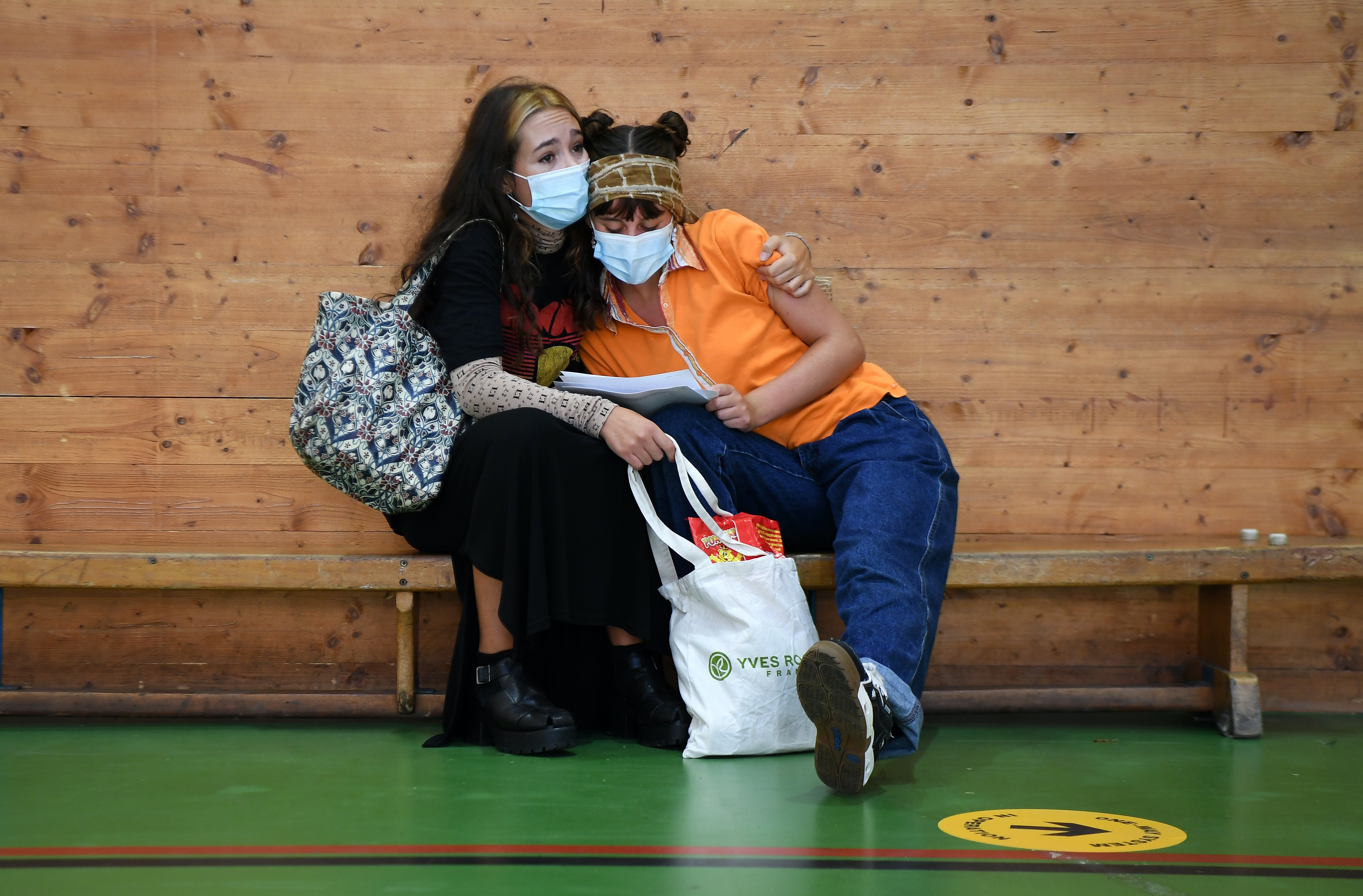 Two young people wearing masks.