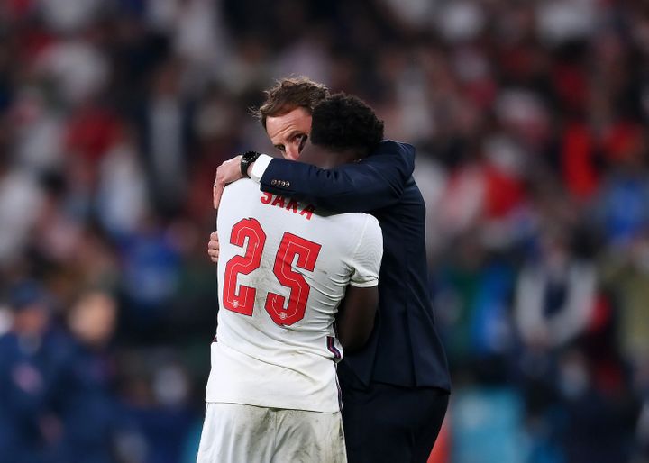 Bukayo Saka of England is consoled by head coach Gareth Southgate after his penalty miss during the UEFA Euro 2020 Championsh