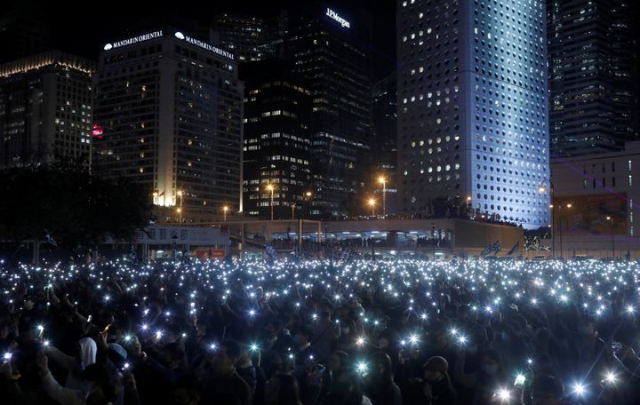A photo taken by journalist Danish Siddiqui captures anti-government protesters as they hold up their mobile phones during a 