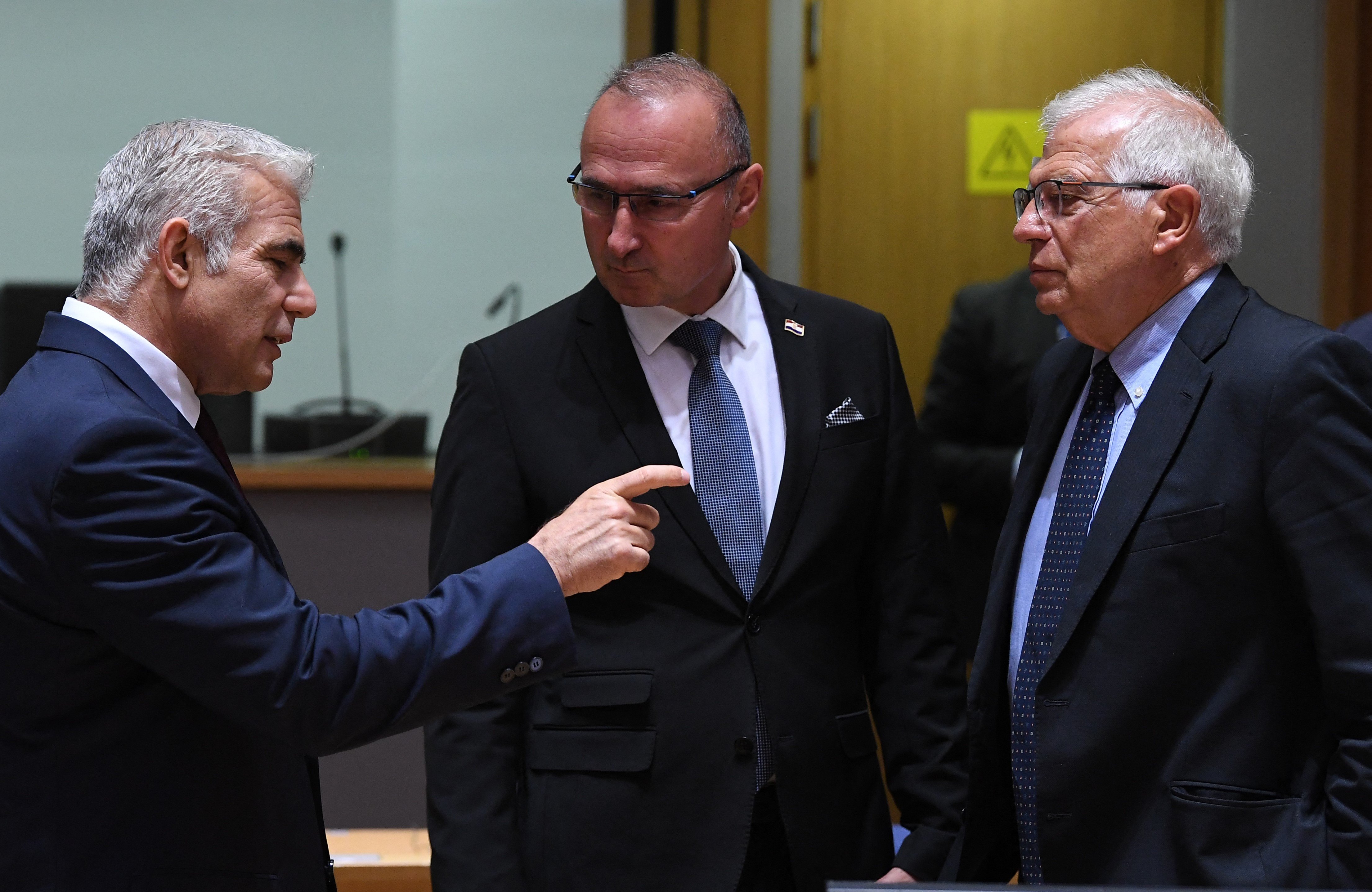 Israeli Foreign Minister Yair Lapid (L) talks with Crotian Foreign Minister Gordan Grilc Radman (C) and European High Representative of the Union for Foreign Affairs Josep Borrell (R) (AFP)