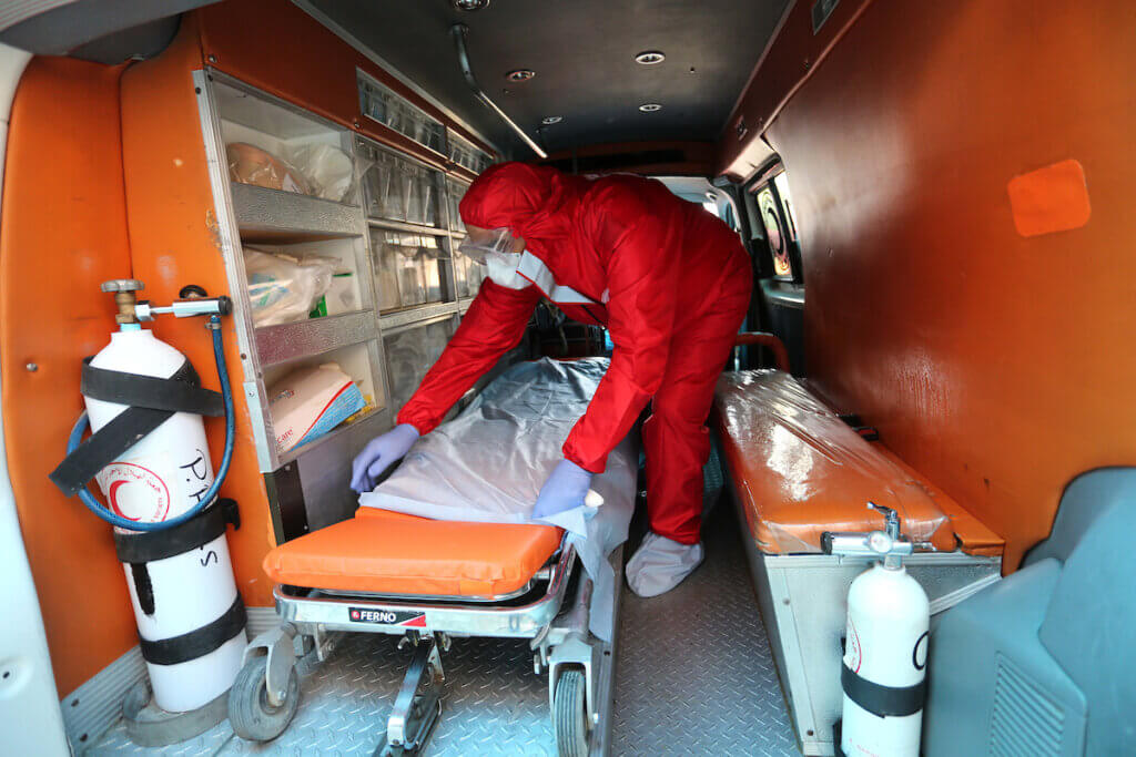 Red Crescent emergency responders disinfect ambulances in Deir al-Balah in central Gaza on August 30, 2020. (Photo: Ashraf Amra/APA Images)
