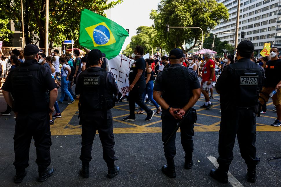 Rio de Janeiro police officers monitor a demonstration against Bolsonaro's handling of the COVID-19 pandemic. Brazil's police