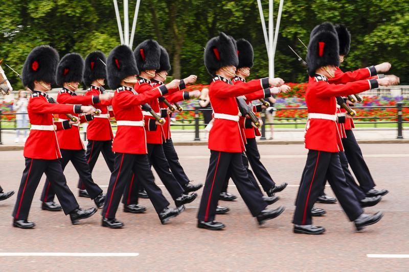 Members of the public watch the Changing of the Guard ceremony at Buckingham Palace, London, Monday August 23, 2021, which is