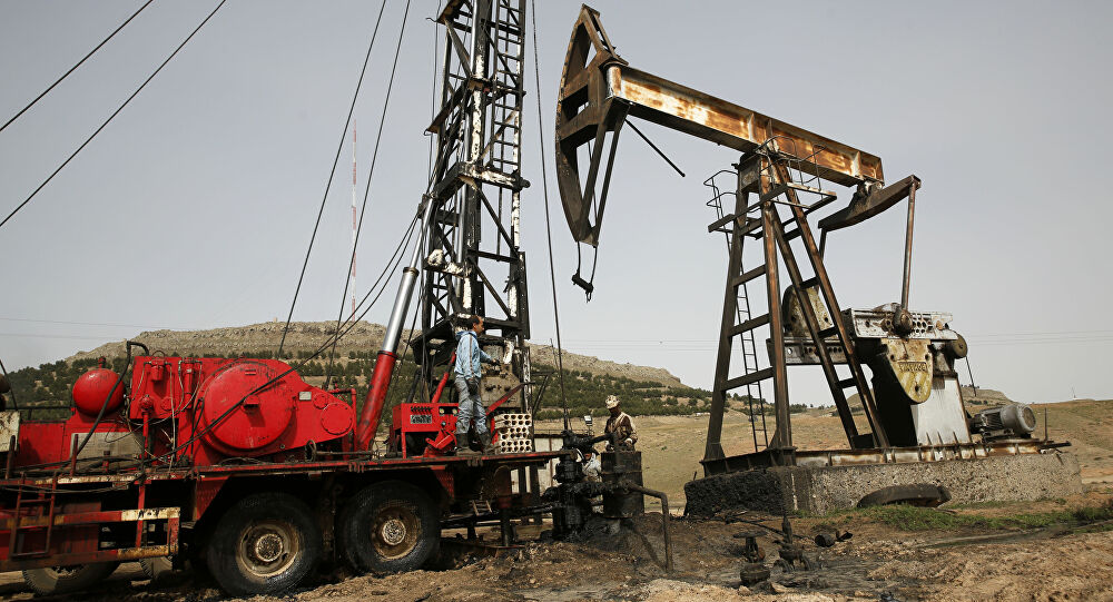 This March 27, 2018 file photo shows Syrian workers fixing pipes of an oil well at an oil field controlled by a U.S-backed Kurdish group, in Rmeilan, Hassakeh province, Syria.