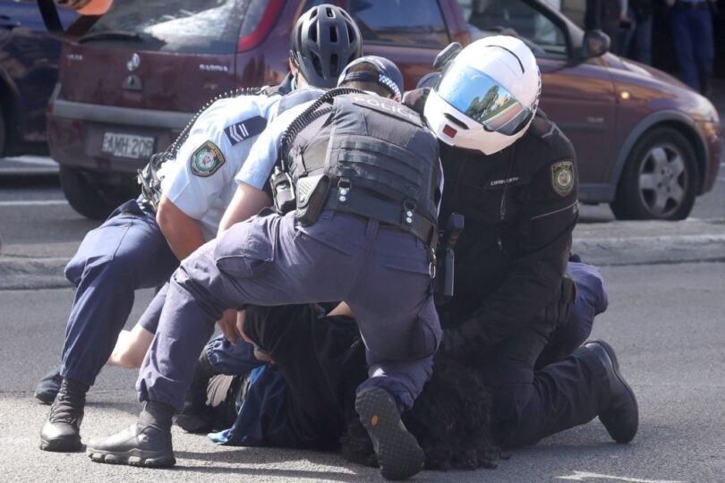police officers detain a protestor in sydney on august 21, 2021, following calls for an anti lockdown protest