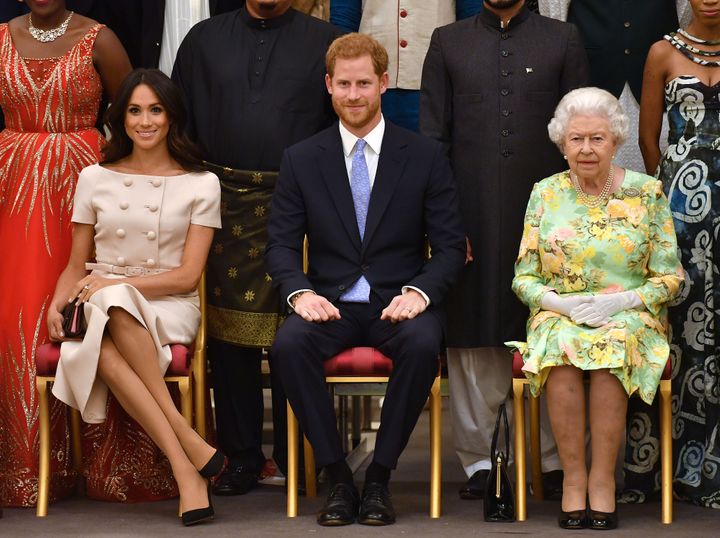The Duke and Duchess of Sussex and Queen Elizabeth II at the Queen's Young Leaders Awards Ceremony at Buckingham Palace on Ju