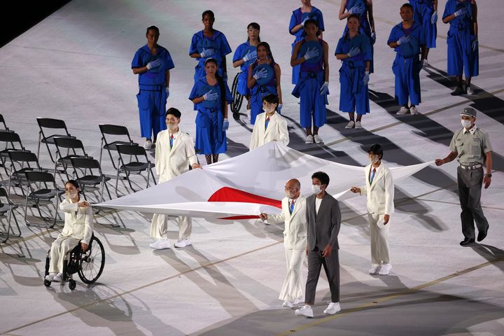 The Japanese flag is carried into the stadium during the opening ceremony of the Tokyo 2020 Paralympic Games at the Olympic S