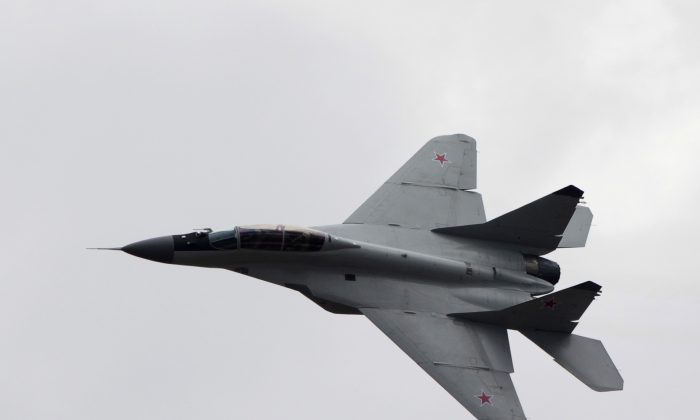 A Russian MiG-29 plane flies during a celebration marking the Russian air force's 100th anniversary in Zhukovsky, outside Moscow, Russia on Aug. 11, 2012. (AP Photo/Misha Japaridze)
