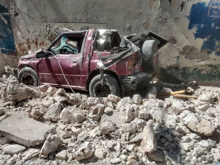 JEREMIE, HAITI - AUGUST 14: A photo shows a damaged car in the rubble after a 7.2 magnitude earthquake struck the country on 