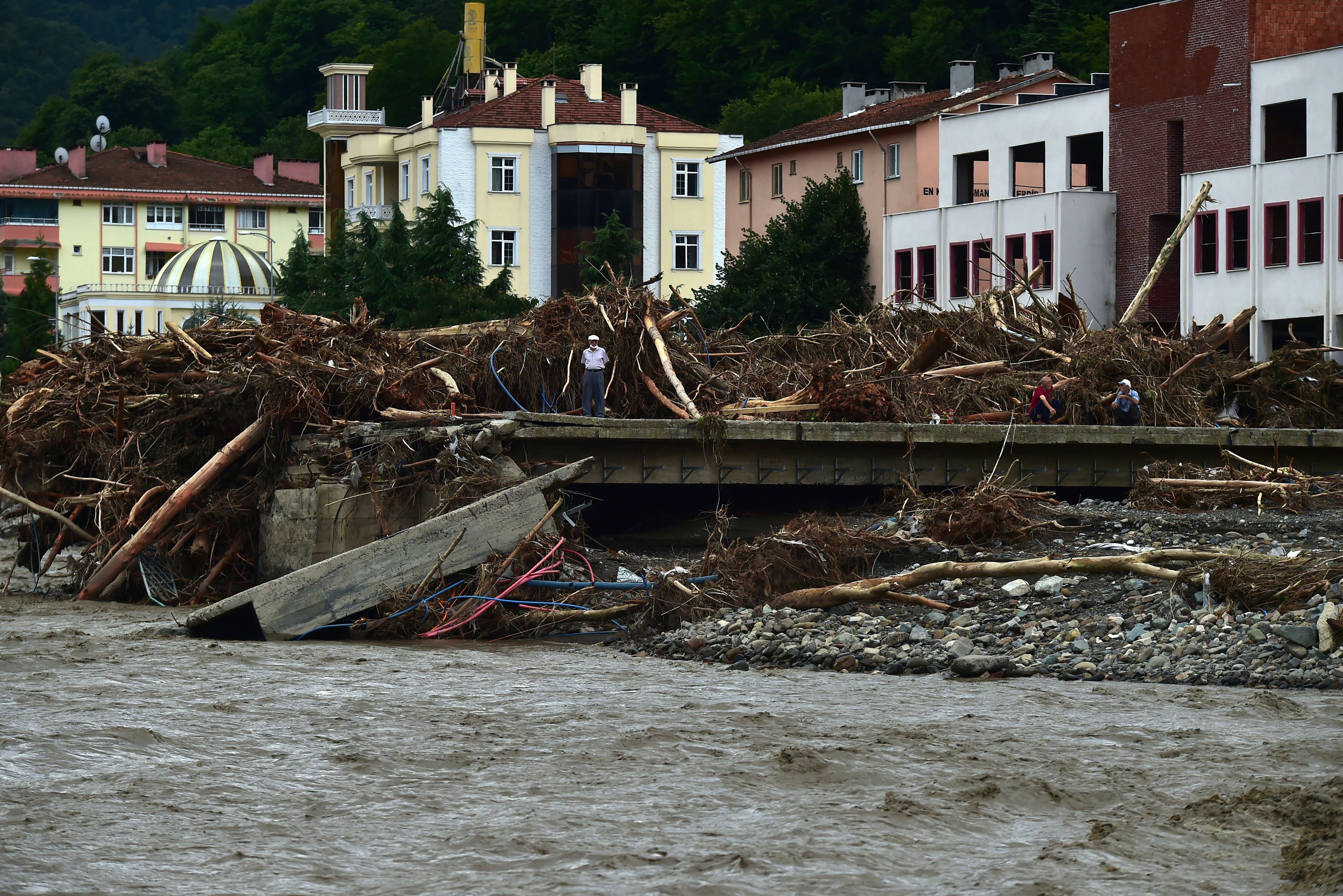 A man watches the destruction after floods and mudslides killed about three dozens of people, in Bozkurt town of Kastamonu pr