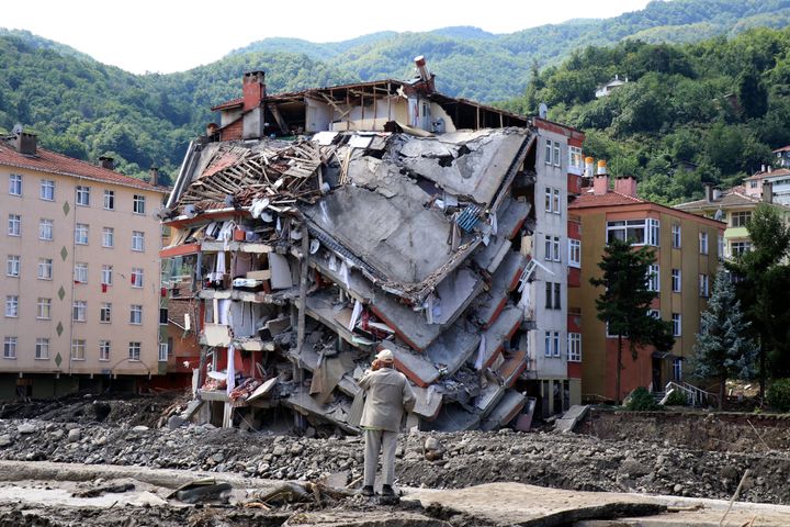 A man looks at destroyed building, in Bozkurt town of Kastamonu province, Turkey, Saturday, Aug. 14, 2021.&nbsp;