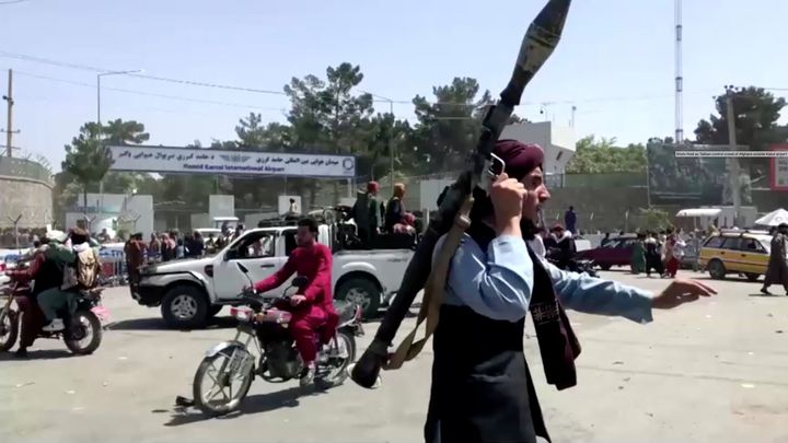 A Taliban fighter doing crowd-control outside Kabul airport.