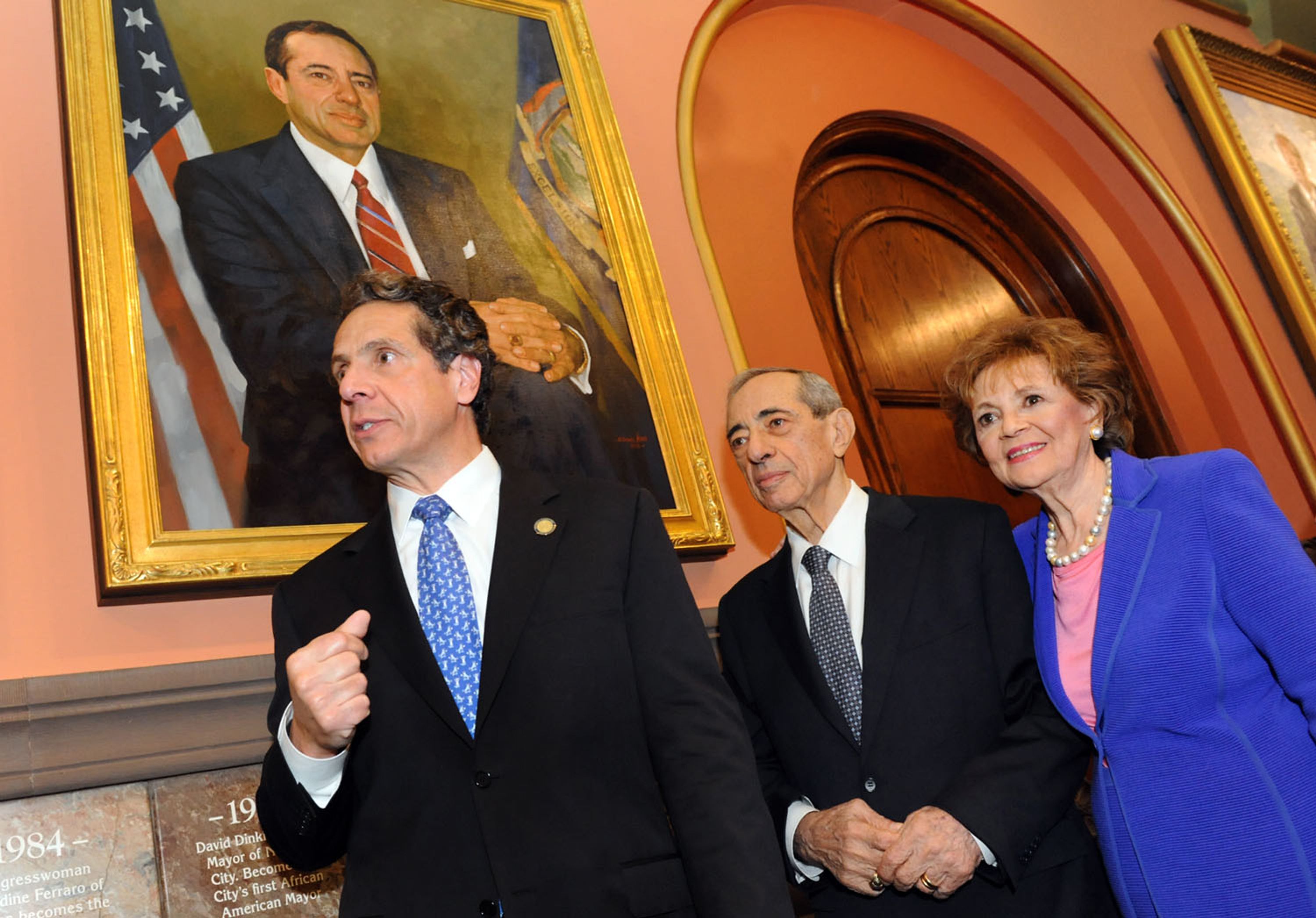 New York Gov. Andrew Cuomo joins his father, left; former Gov. Mario Cuomo, and mother, former first lady Matilda Cuomo, as the elder Cuomo's portrait is revealed in the Hall of Governors on Saturday, June 15, 2013, at the state Capitol in Albany, N.Y.