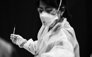 A nurse holding a vaccine needle