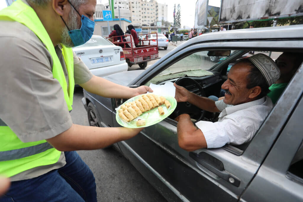 Palestinians distribute sweets after the escape of six Palestinian prisoners, in Gaza City, on September 6, 2021. (Photo: Ashraf Amra/APA Images)