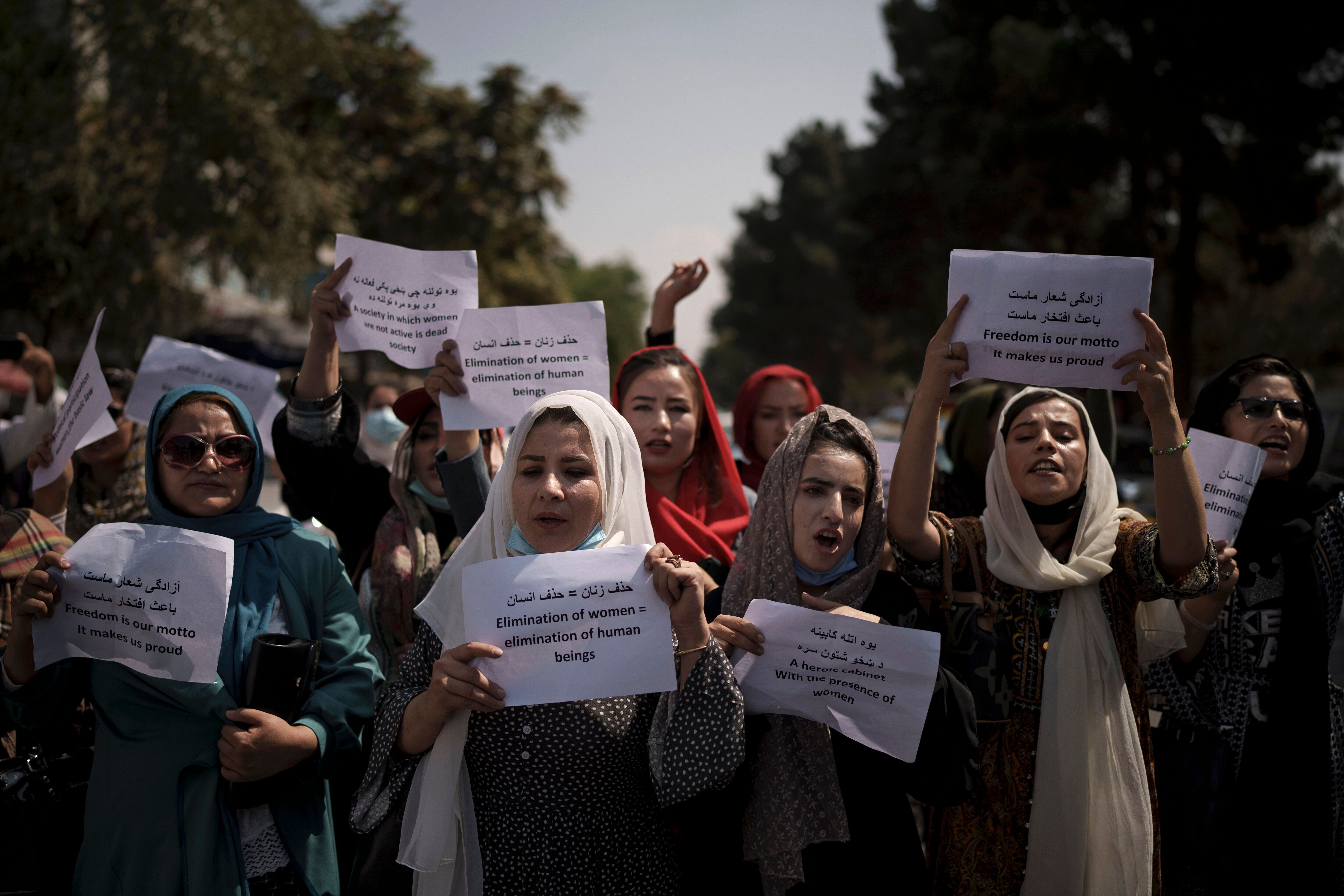 Afghan women march to demand their rights under the Taliban rule during a demonstration near the former Women's Affairs Minis