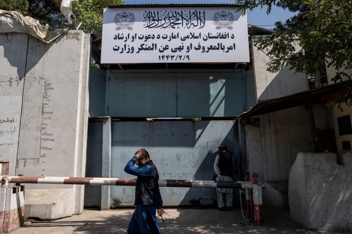 An Afghan man walks past the former Women's Affairs Ministry building in Kabul on Sept. 18.