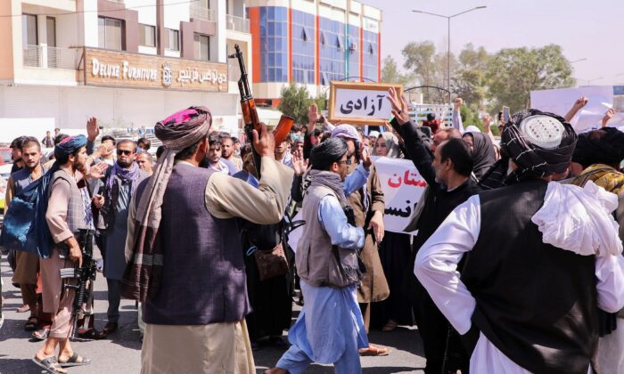Taliban fighters try to stop the protesters, as they shout slogans during an anti-Pakistan protest, near the Pakistan embassy in Kabul, Afghanistan, on Sept. 7, 2021. (Stringer/Reuters)