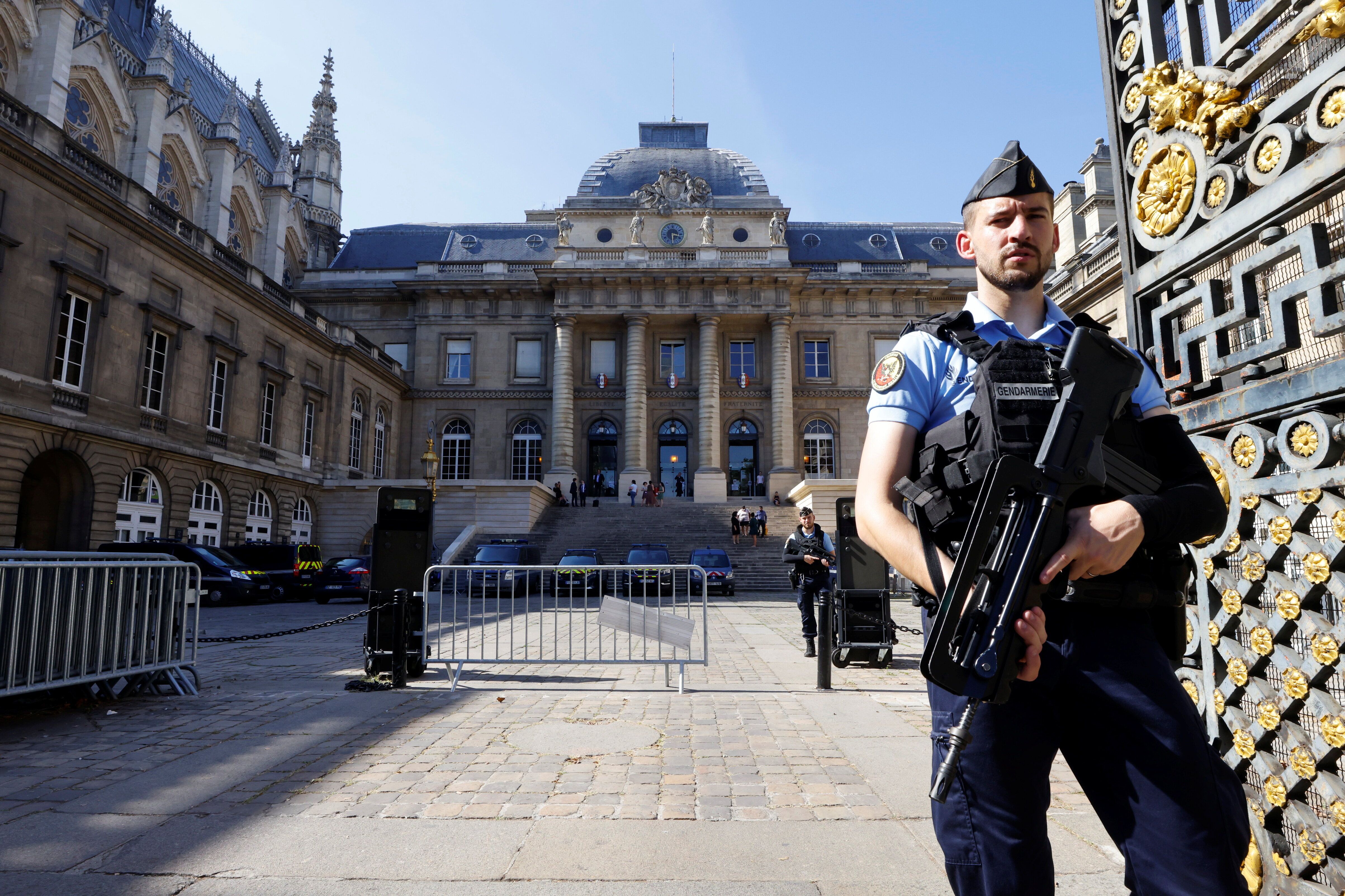 French police stand guard in front of the courthouse on the Ile de la Cite ahead of the opening of the trial of the 2015 Pari