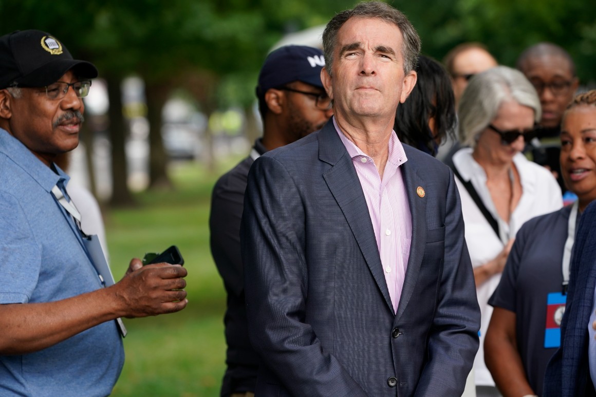 Governor Ralph Northam stands in a crowd outside.