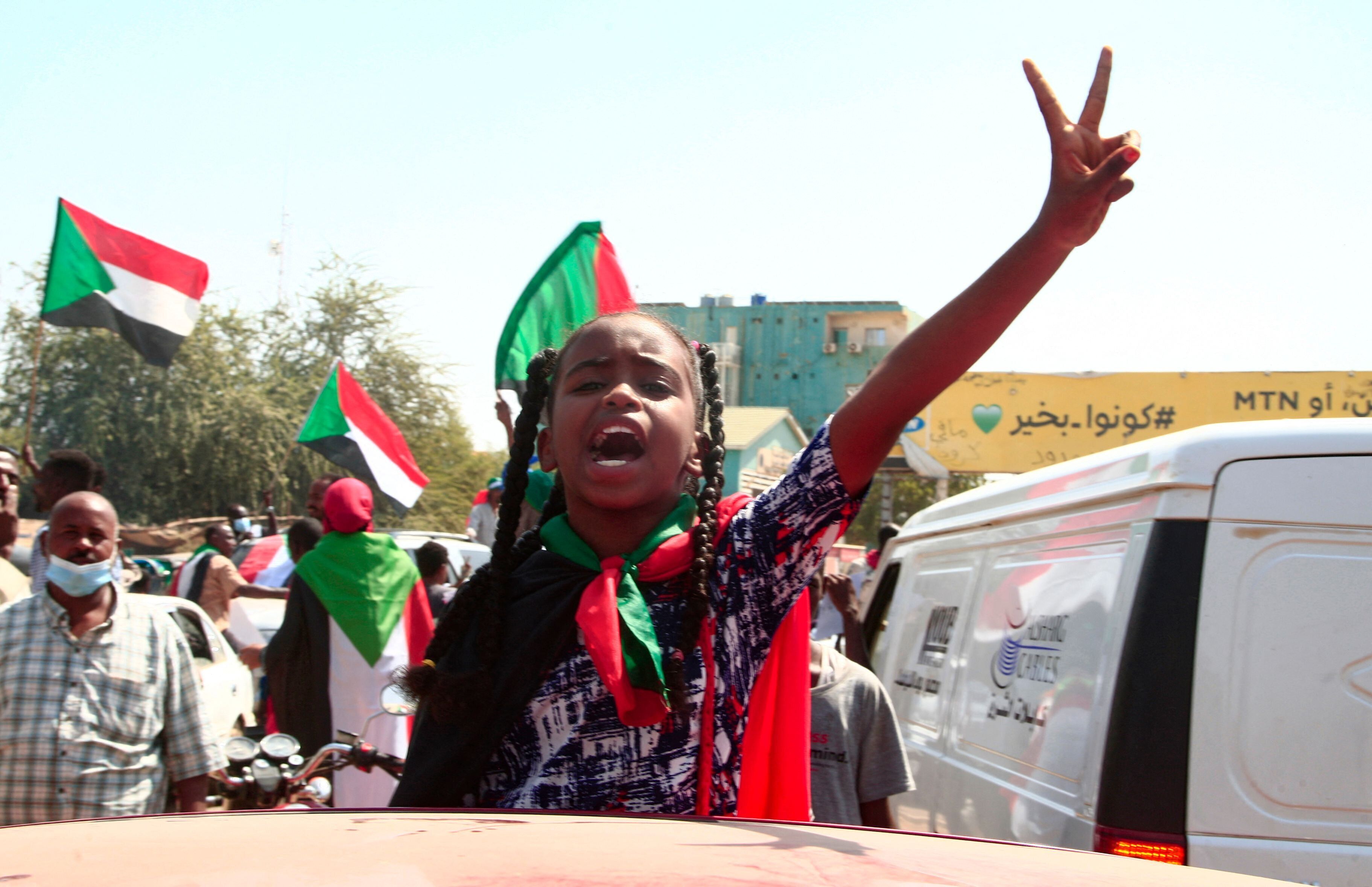 A young Sudanese girl takes part in a demonstration in Omdurman, the capital Khartoum's twin city, to demand the government's transition to civilian rule, on October 21, 2021. - Supporters of Sudan's transitional government took to the streets of the capital today as rival demonstrators kept up a sit-in demanding a return to military rule. The mainstream faction backs the transition to civilian rule, while supporters of the breakaway faction are demanding the military take over. (Photo by Ebrahim HAMID / AFP) (Photo by EBRAHIM HAMID/AFP via Getty Images)