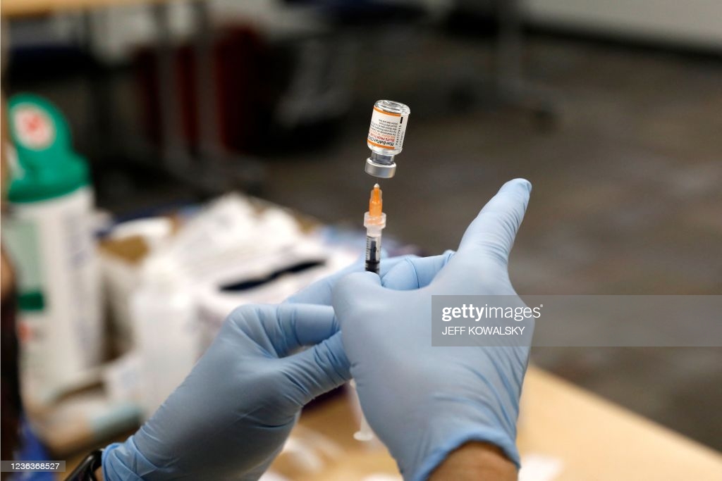 Nurse practitioner Sarah Rauner fills a syringe with the Pfizer Covid-19 vaccine to be administered to children from 5-11 years old are seen at the...