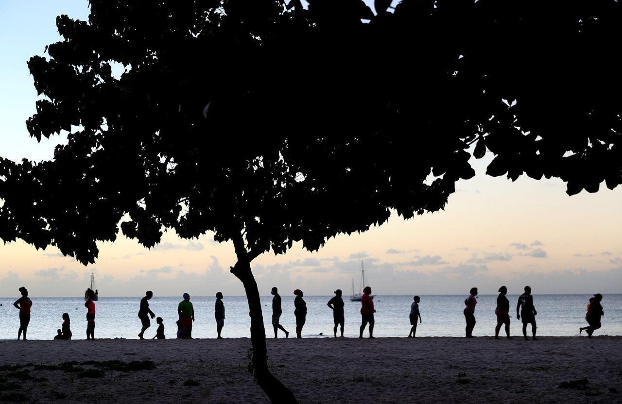 People exercise on the beach on in Bridgetown, Barbados. Some Barbadians have voiced concerns that the current process of moving to a republic has not involved the country's people.