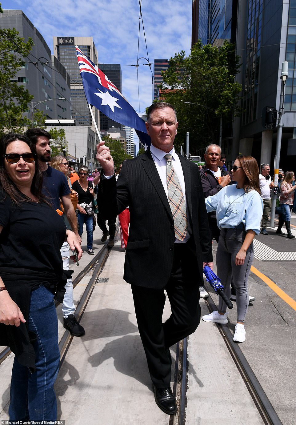 A well dressed protester wearing a suit was spotted amid the crowd during protests in the Melbourne CBD on Saturday